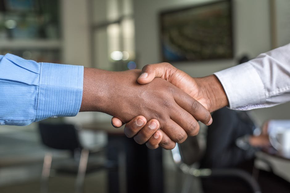 A picture showing two hands, one representing technology and the other representing ethics, shaking hands to symbolize a collaboration for responsible GAN usage.