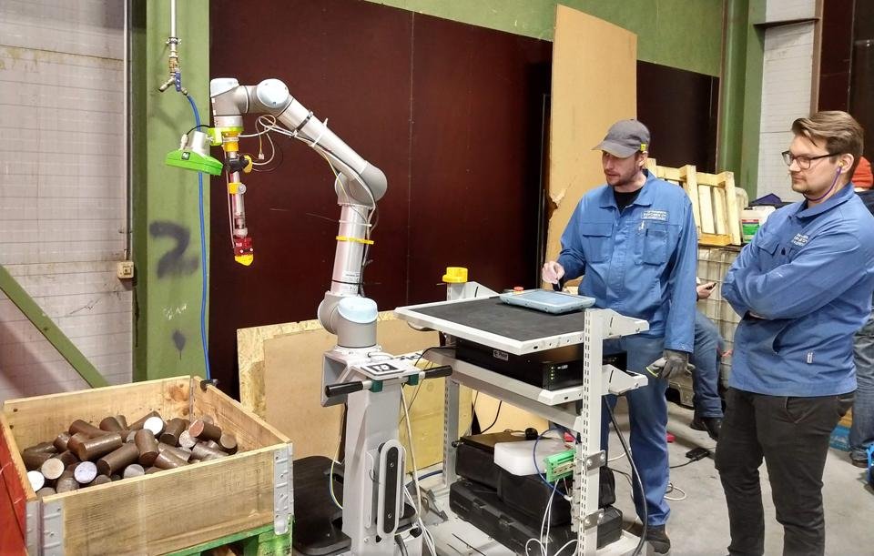 A collaborative robot (cobot) working alongside a human worker in a manufacturing setting