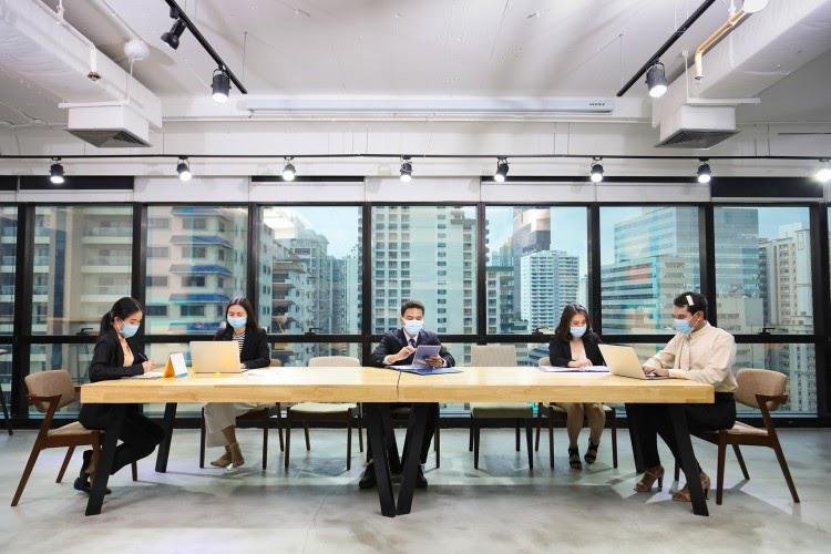 A diverse group of professionals representing DeepMind's AI oversight councils in a modern meeting room