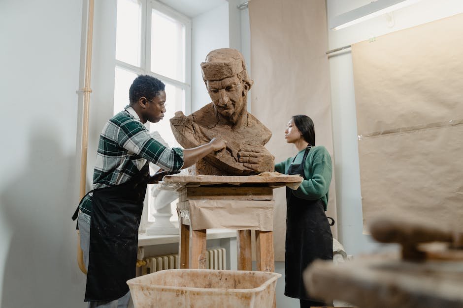 Sculptor shaping a clay model with the assistance of AI technology