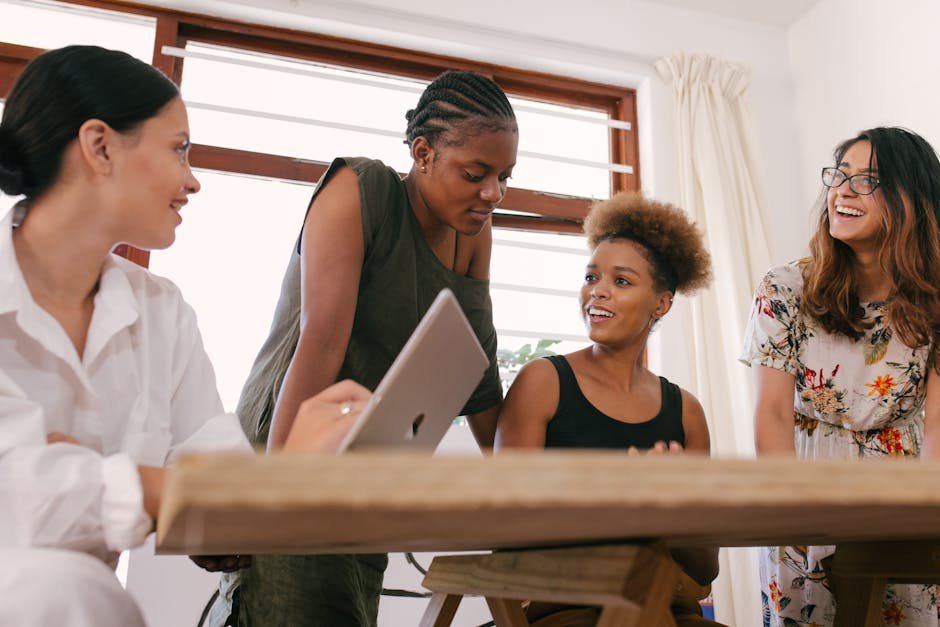 A diverse team of AI developers, with an equal representation of men and women, working on creating unbiased AI systems