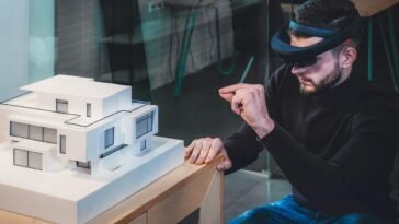 a man wearing virtual reality goggles to design architecture